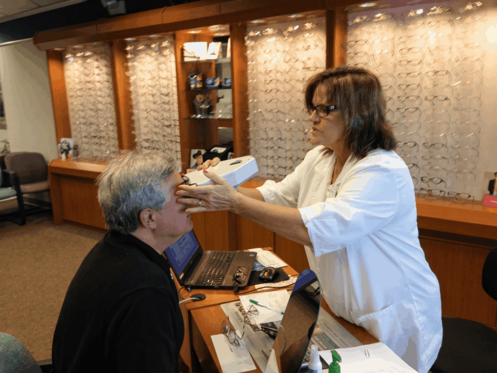A behind-the-scenes view of the advanced diagnostic technology used for a comprehensive eye exam in a clinical exam room at Louisville Laser & Eye.
