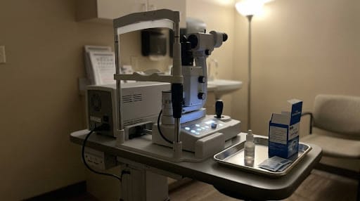 An in-office YAG laser machine and a prep tray with anesthetic drops set up for a non-surgical laser vitreolysis eye floater treatment.